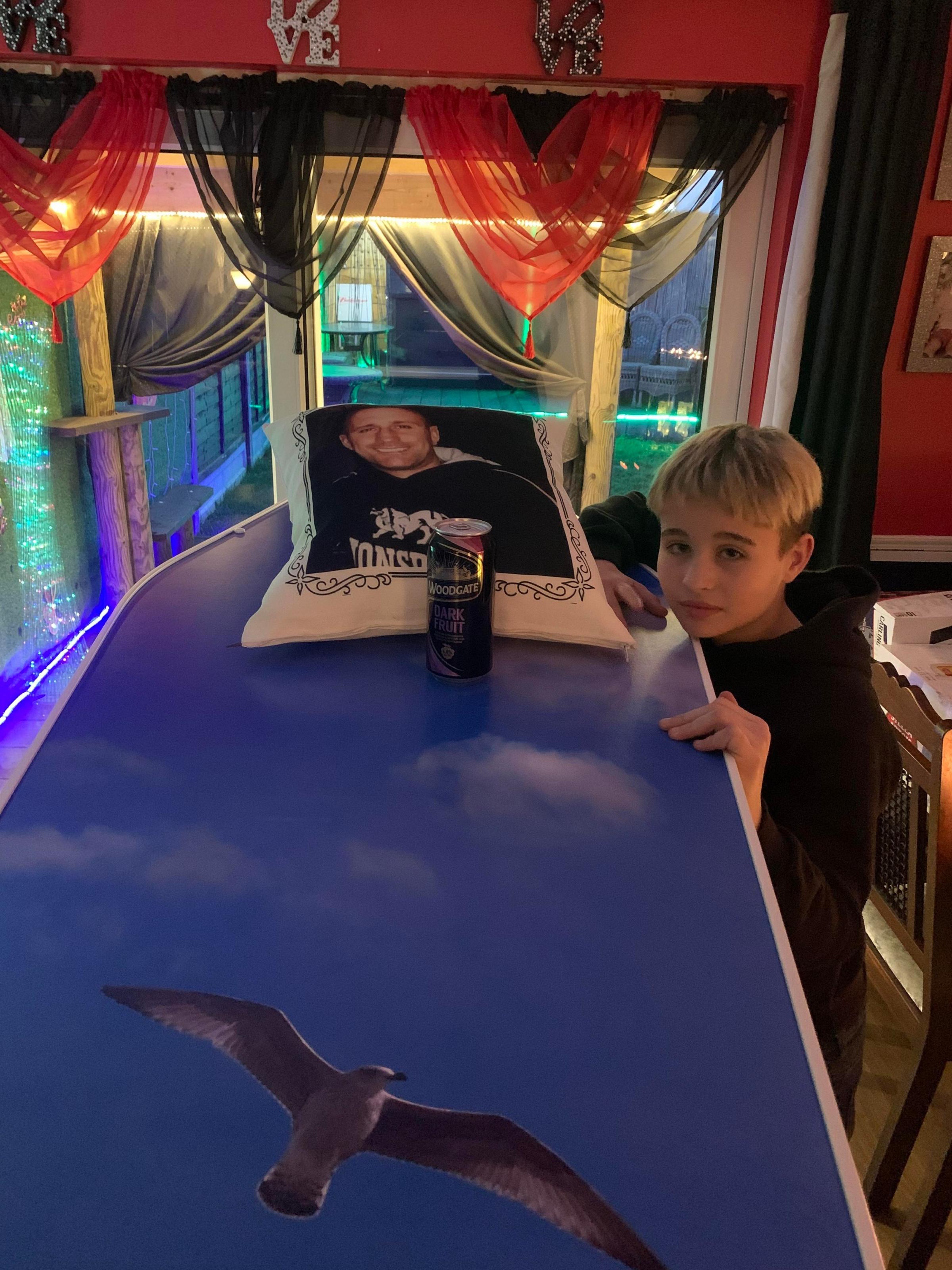 Best dad - Alexis, 14, with his fathers coffin.